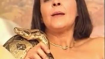 Blonde and dark-haired vixens are fucking a raging serpent